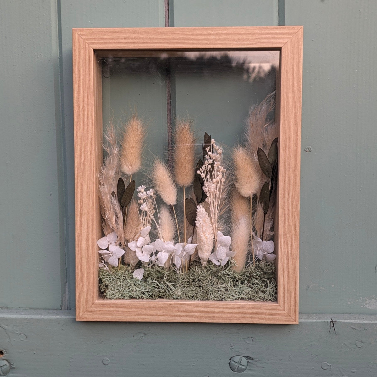 Cadre La Clairière de la collection Soria, création florale en volume composée de fleurs séchées dans des tons naturels entre deux plaques de verre.